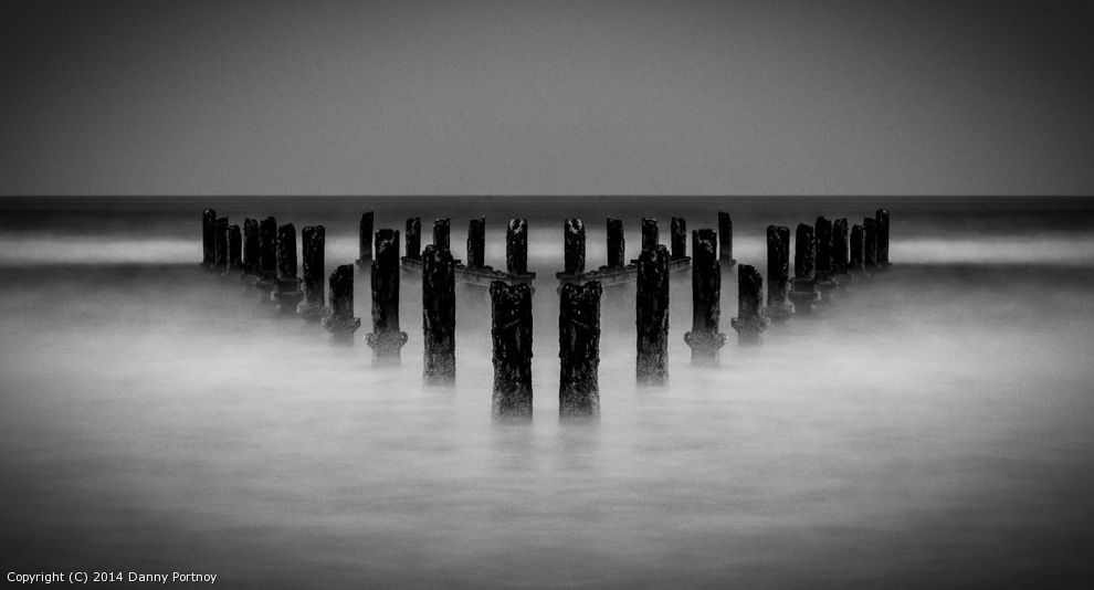 Pilings in the sea by dannypo